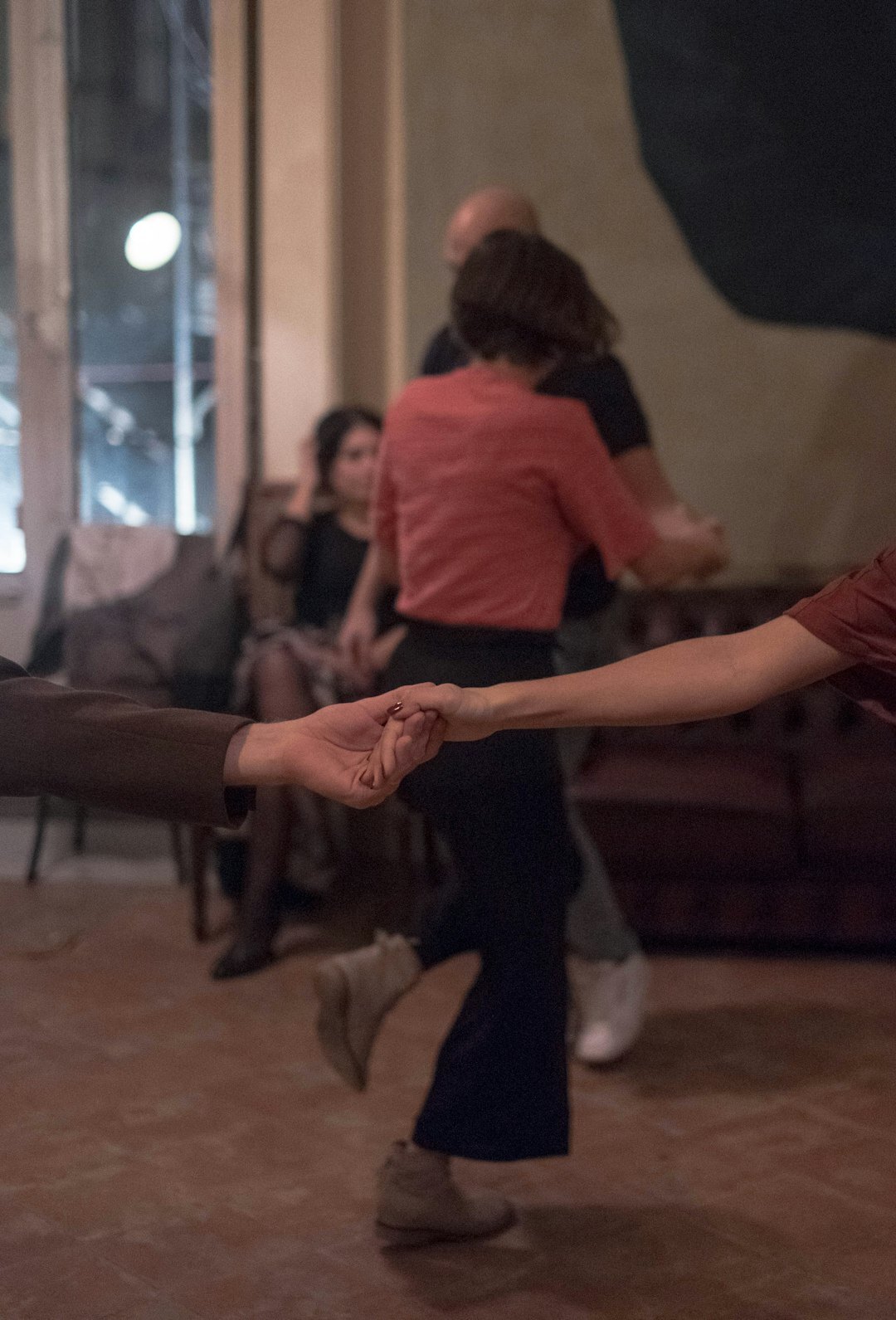 Senior couples dancing together in a bright community hall